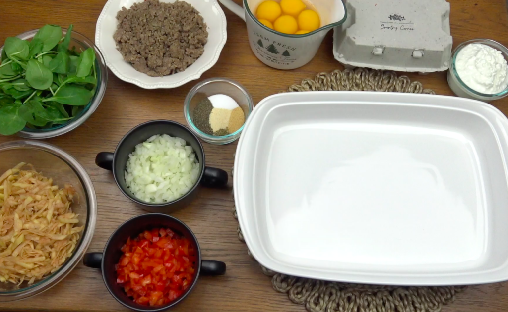 egg casserole ingredients laid out on table with dish.